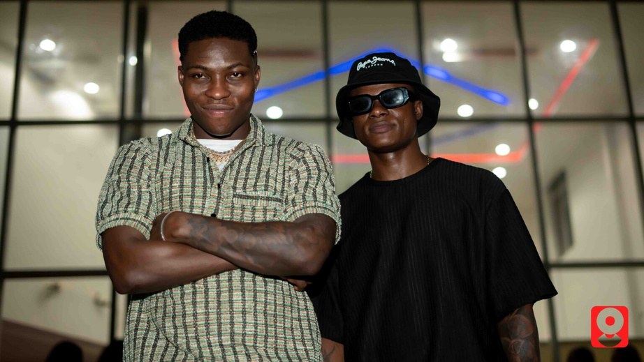 DJ Kenny standing with a collaborator at an evening event